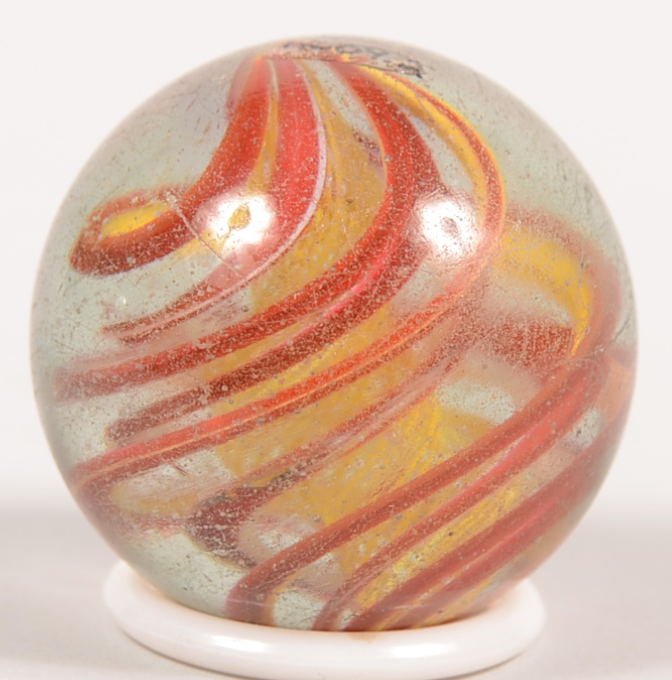 Antique Two Stage Latticino Swirl Marble. A spiral: Antique Two Stage Latticino Swirl Marble. A spiral yellow latticino core surrounded by a four band red and yellow swirl. 1 1/2"dia.