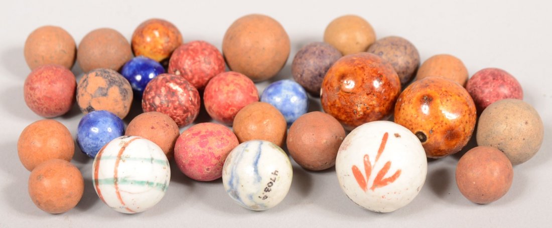 Group of Handmade Marbles. Ranging from a 7/8"dia.: Group of Handmade Marbles. Ranging from a 7/8"dia. milk glass with black concentric circles and red sprig, to 3/4"dia. Manganese glazed stoneware to a 7/16"dia. cobalt glazed marble. 30 pieces.