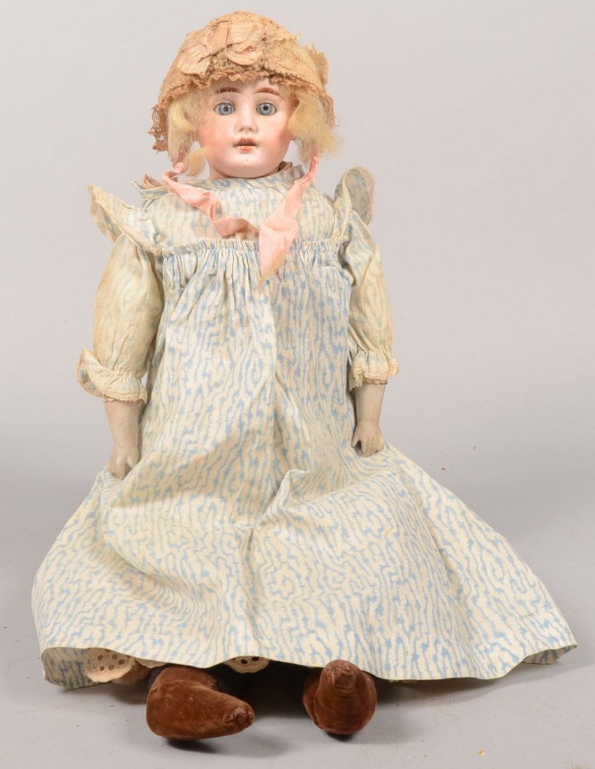 Bisque Head Doll with Real Hair. Doll has white ki: Bisque Head Doll with Real Hair. Doll has white kid body with compound sewn joints, black jersey on calves with brown velvet "shoes" and early needlepoint cap and undergarments with a blue on white co