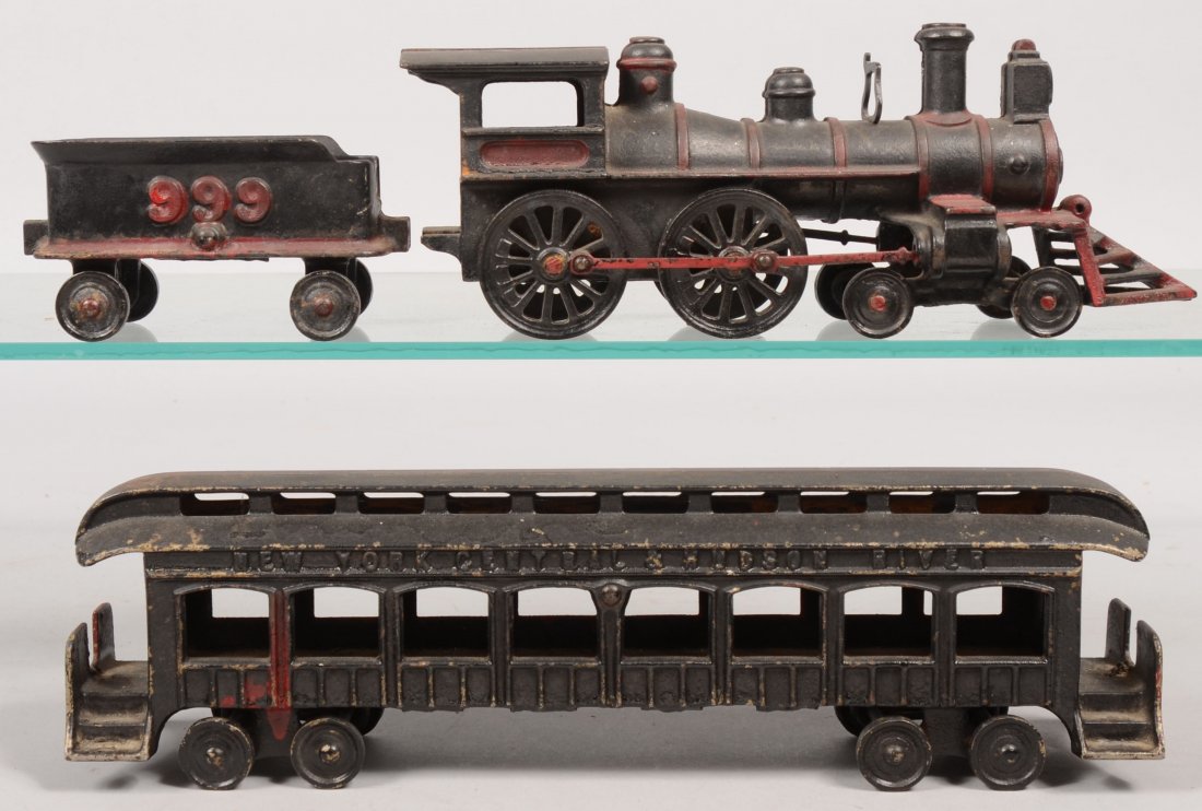 Wilkins Three Piece Cast Iron Train. Including: Lo: Wilkins Three Piece Cast Iron Train. Including: Locomotive with drive rods on wheels, 10 1/8"l., "999" tender car, 4 7/8"l. and a passenger car marked: "New York Central & Hudson River", 13"l. All pai