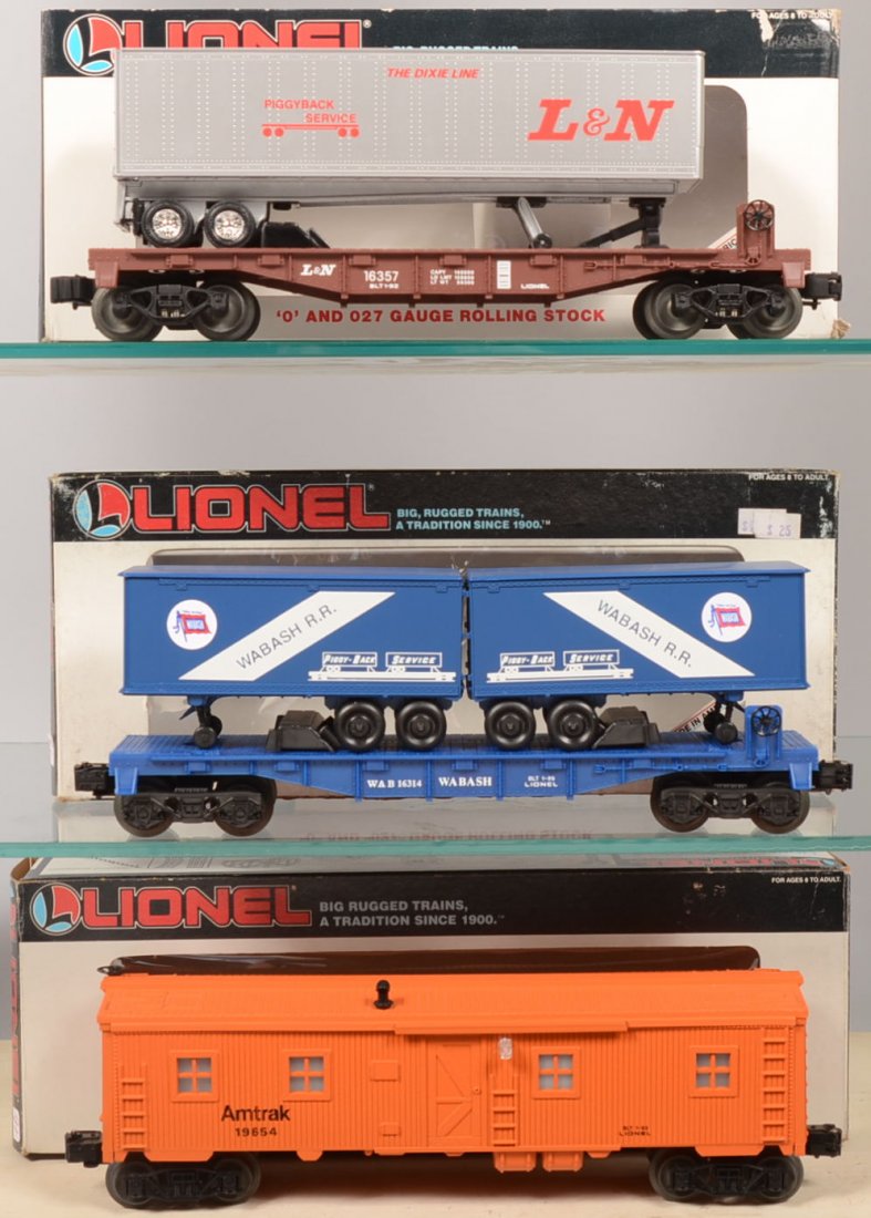 Three Lionel Rail Cars in Boxes. 16314, Wabash Fla: Three Lionel Rail Cars in Boxes. 16314, Wabash Flat Car with Trailers. Blue car with two "Piggy-Back Service" WABASH trailers in blue all with white lettering. 19654, orange Amtrak Bunk Car with light