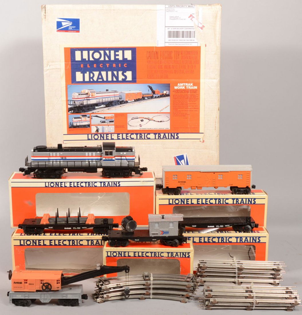 Lionel "Amtrak Work Train" Layout #11723. Includin: Lionel "Amtrak Work Train" Layout #11723. Including: 18815, Amtrak RS-3 Diesel Engine in silver and black with red, white and blue stripe; 16644, Amtrak heavy duty rail crane with orange cabin and gra