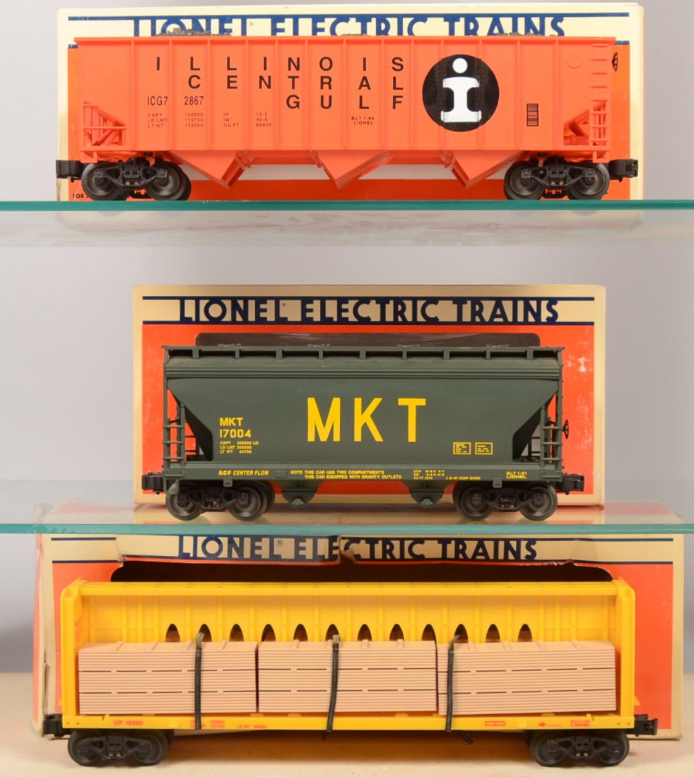 Three Lionel Rail Cars. 16380, Union Pacific Cente: Three Lionel Rail Cars. 16380, Union Pacific Center I Beam Flatcar with wood pallets, red on yellow; 17121, orange Illinois Central Gulf Three Bay Hopper with Coal load; 17004, MKT Center flow Hopper 