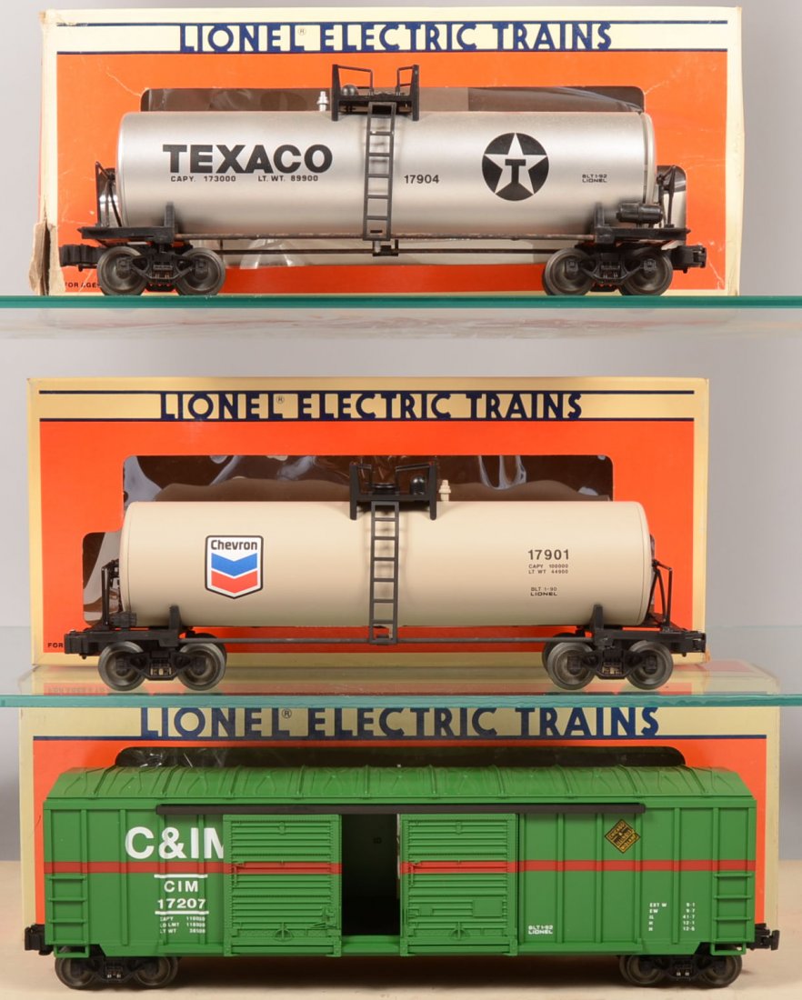 Three Lionel Rail Cars. 17207, Chicago & Illinois : Three Lionel Rail Cars. 17207, Chicago & Illinois Midland Double-Door Box Car in green with brown stripe; 17901, light gray Chevron Uni-Body Tank Car on black chassis; 17904, silver and black Texaco U