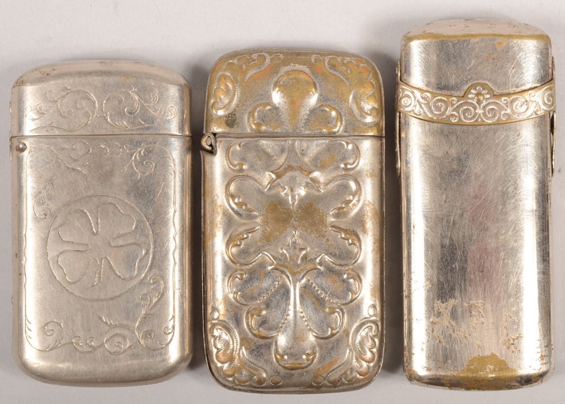 Three Plated Brass Match Safes. An embossed design : Three Plated Brass Match Safes. An embossed design box with spring hinged lid, unmarked, 2 7/8"l. An incised four leaf clover design with spring hinged lid, unmarked, 2 3/4"l. And a pain case with a f