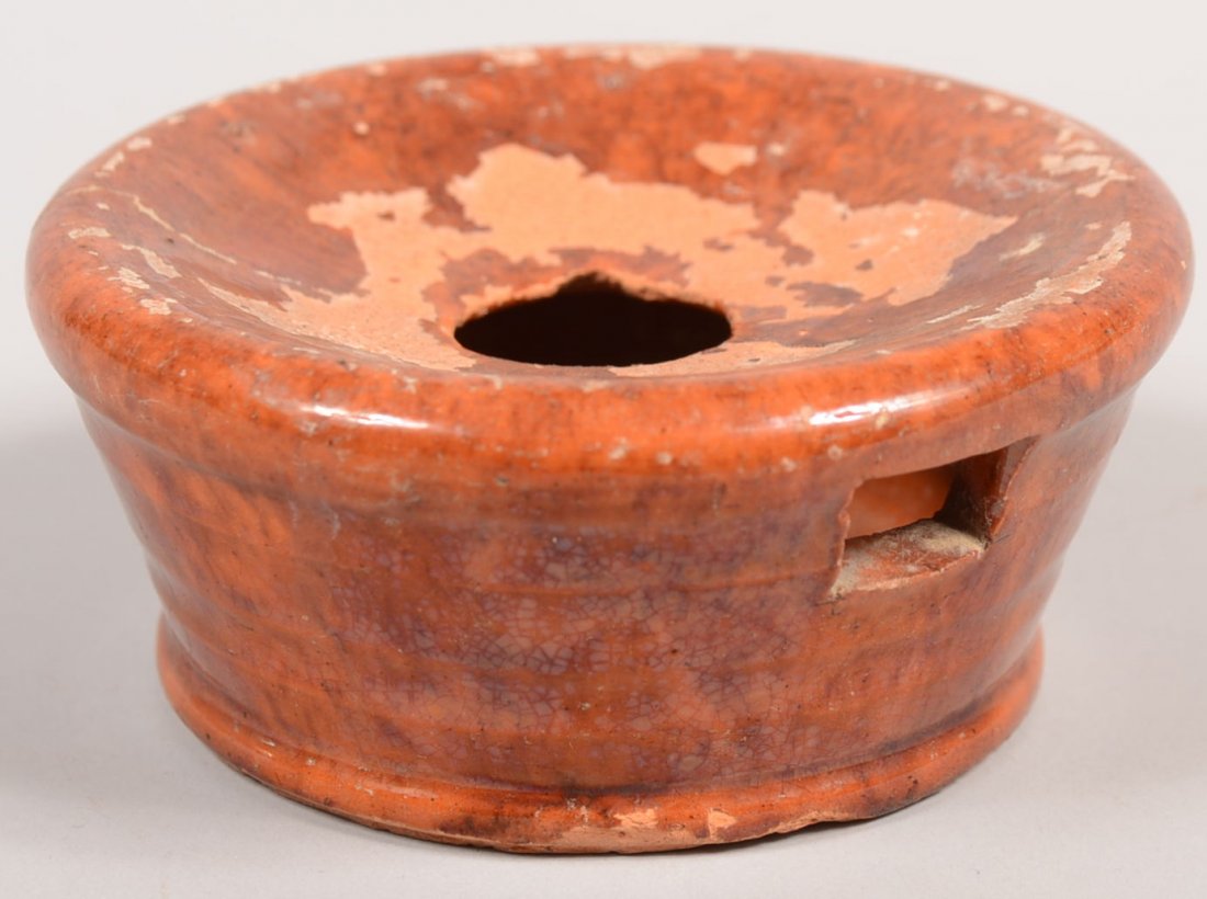 Circular Redware Hand Spitoon. Small personal cove: Circular Redware Hand Spitoon. Small personal covered cup with hole in center of depressed cover and another hole on side for drainage. Tapered sided vessel has a bead foot and manganese "salting" in