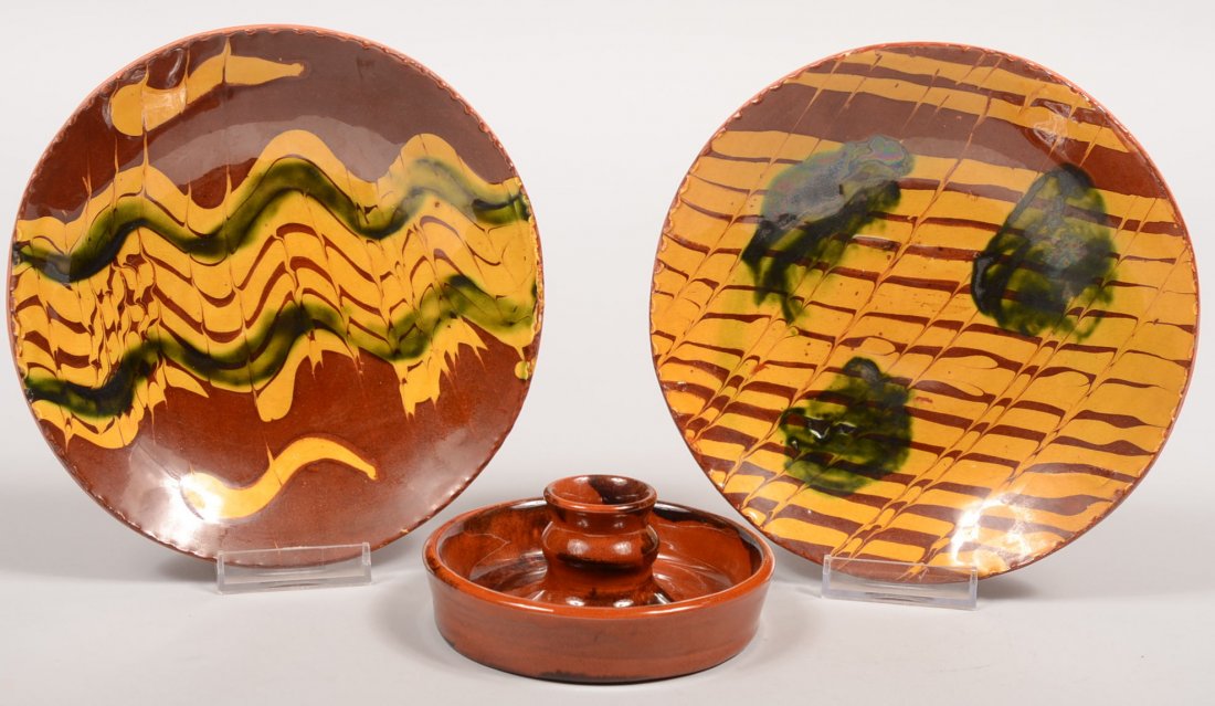 Two Small Redware Dishes with a Candle Cup. Both w: Two Small Redware Dishes with a Candle Cup. Both with multiple combed yellow slip lines with green accents. One back marked: "L. Breininger, Robesonia, PA. May 14, 1983, Next day." Other without marks
