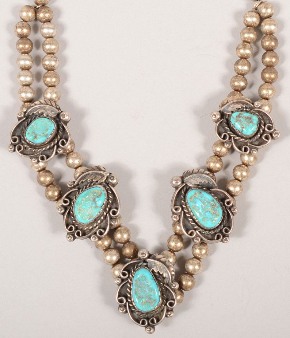 Navajo Turquoise and Silver Double Strand Necklace: Navajo Turquoise and Silver Double Strand Necklace. Five turquoise nuggets having feather, berry and scroll black matrix settings along the double strands of silver hollow beads strung on a chain. 17