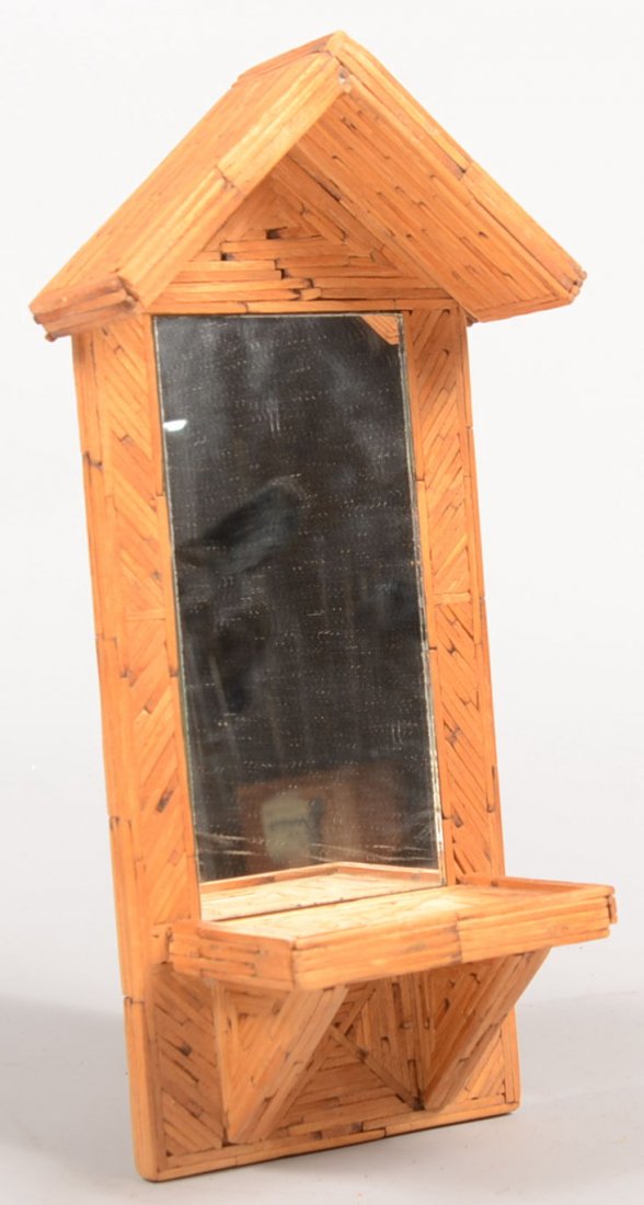 Tramp Art Burnt Match Wall Vanity. A wall mounted: Tramp Art Burnt Match Wall Vanity. A wall mounted plaque with a overhanging eve, a bracketed shelf and a enframed mirror plate. Hanger on back is old beer can tab. 13 1/4"h. X 6 1/2"w. Condition: Good