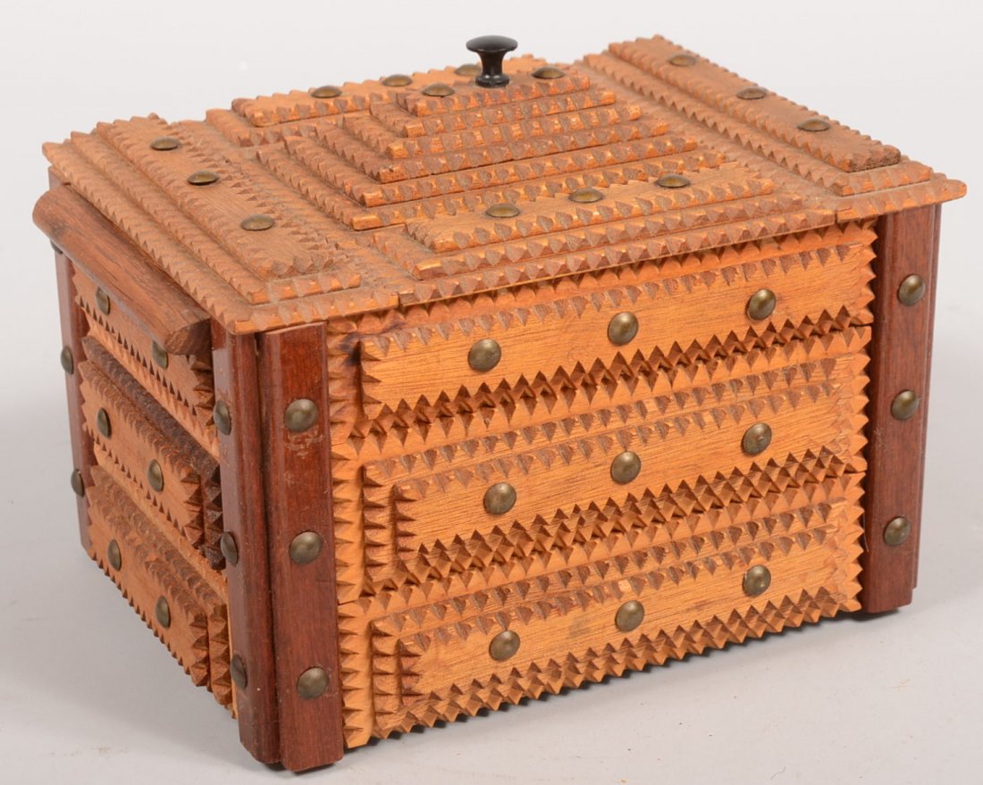 Tramp Art Dresser Box. Contrasting woods with chip: Tramp Art Dresser Box. Contrasting woods with chip carved panels and brass headed tacks decorate this box. Hinged lift lid has a seven layer pyramid on top center with black knob. Interior lined with 