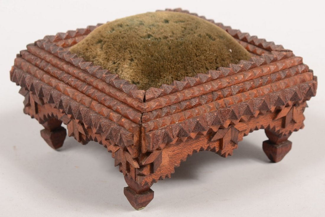 Small Square Footed Tramp Art Pin Cushion. Dark br: Small Square Footed Tramp Art Pin Cushion. Dark brown chip carved frame with legs has a green velvet pin cushion on it's top. Arched skirt with diamond decorations and square cut and profiled legs. 3 