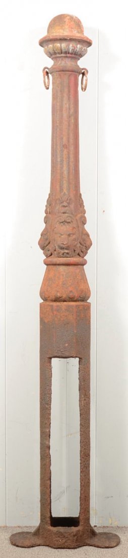 American 19th Century Cast Iron Hitching Post. Dom: American 19th Century Cast Iron Hitching Post. Dome top, Fluted post and embossed lion head design. 66 1/2" high overall. Condition: Good with expected wear and surface rust and pitting.