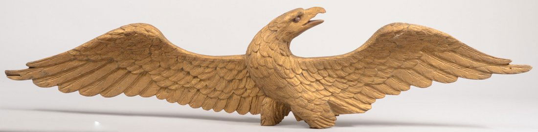 Hand Carved Wooden Spread Eagle Plaque. Boldly car: Hand Carved Wooden Spread Eagle Plaque. Boldly carved feathers and form painted gold. Bent nail on back for hanging. 9"h. X 39 1/8"w. Condition: Missing feet and any banner that may have been with the
