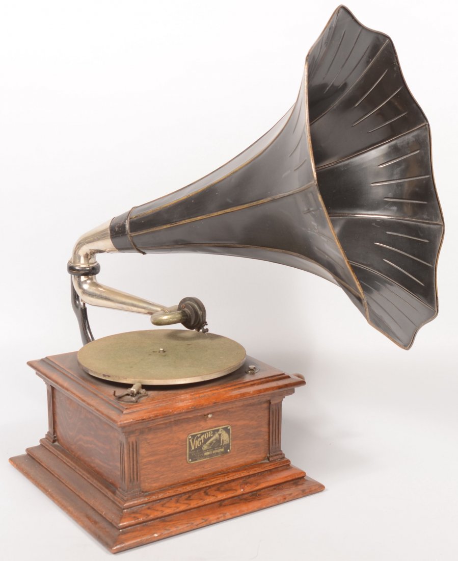 Victor Talking Machine. Table-top wooden disc type: Victor Talking Machine. Table-top wooden disc type record player case with Morning glory shaped trumpet speaker. Crank wound, spring driven device. 28 1/2"h. X 14 1/4" X 14 1/4" Condition: Good with u