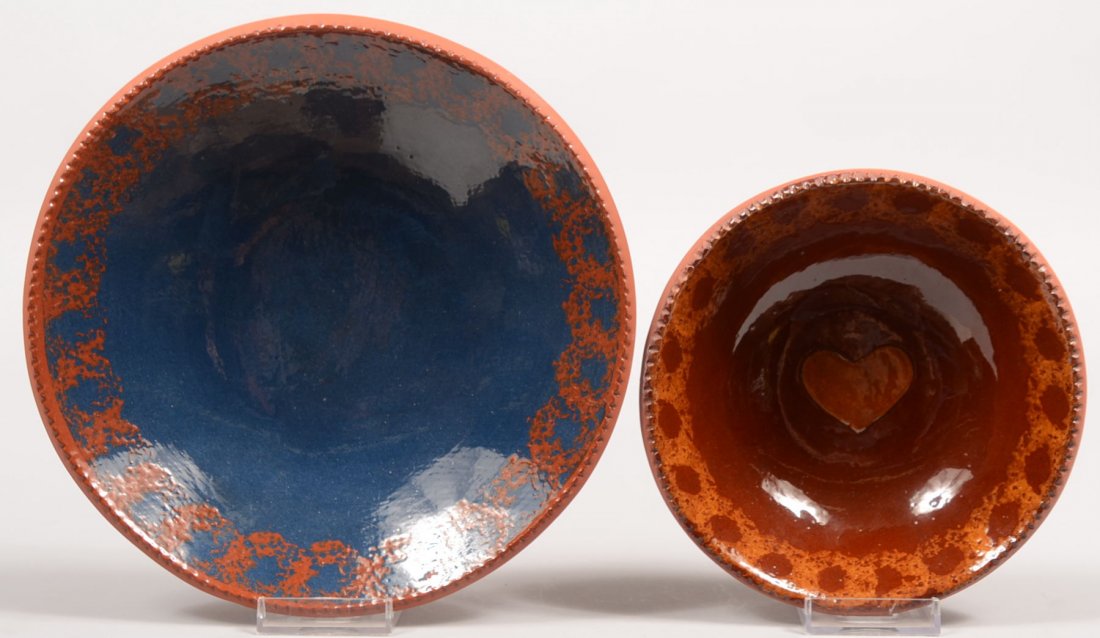 Two C. Ned Foltz Signed Redware Bowls. Larger has: Two C. Ned Foltz Signed Redware Bowls. Larger has sponge decorated coggle rim and solid blue interior. 2"h. X 9"dia. Smaller bowl has sponge decorated coggle rim with yellow slip heart in center. 2 1/