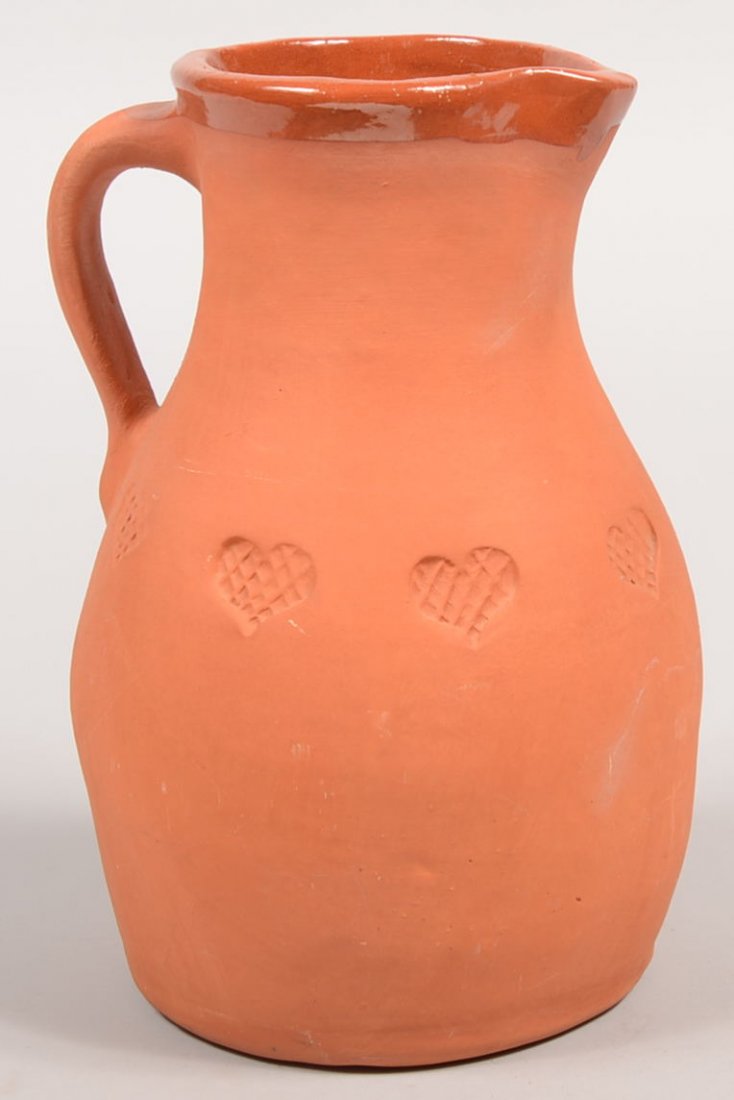 C.N. Foltz Signed Redware Pitcher. Bulbous bottom: C.N. Foltz Signed Redware Pitcher. Bulbous bottom vessel has applied loop handle and stampings of hatched hearts around middle. Rim has pulled spout. Exterior unglazed. Interior salt glazed to just ov