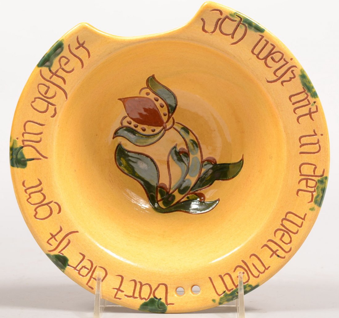Breininger Pottery Redware Shaving Bowl. Wide rim: Breininger Pottery Redware Shaving Bowl. Wide rim bowl with chin notch and holes for hanging thong. Decorated with birds and flowers, a tulip on center and a Pa. Dutch slogan on the rim. Read on botto