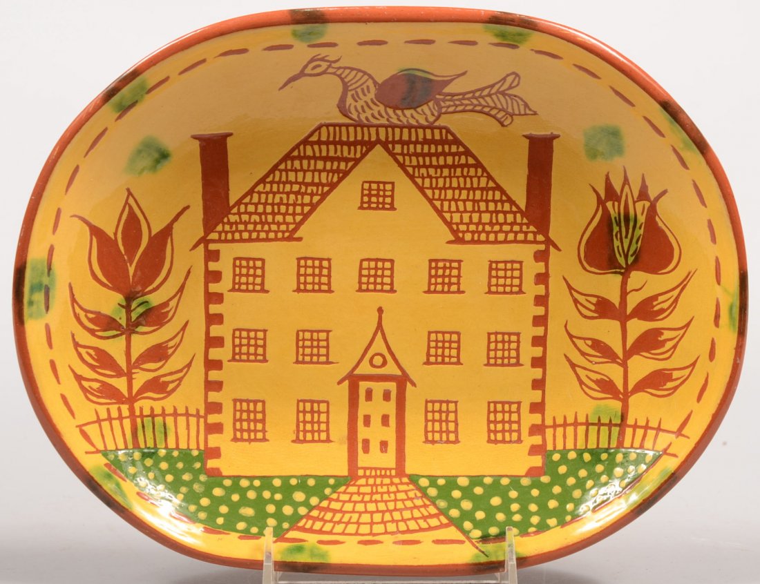 Seagraves Marked Redware Loaf Dish. Oblong dish wi: Seagraves Marked Redware Loaf Dish. Oblong dish with yellow slip exhibits an incised manse with bird on roof and landscaping in green slip. Simply enscribed JCS on back. 11"w. Condition: Good, no dama