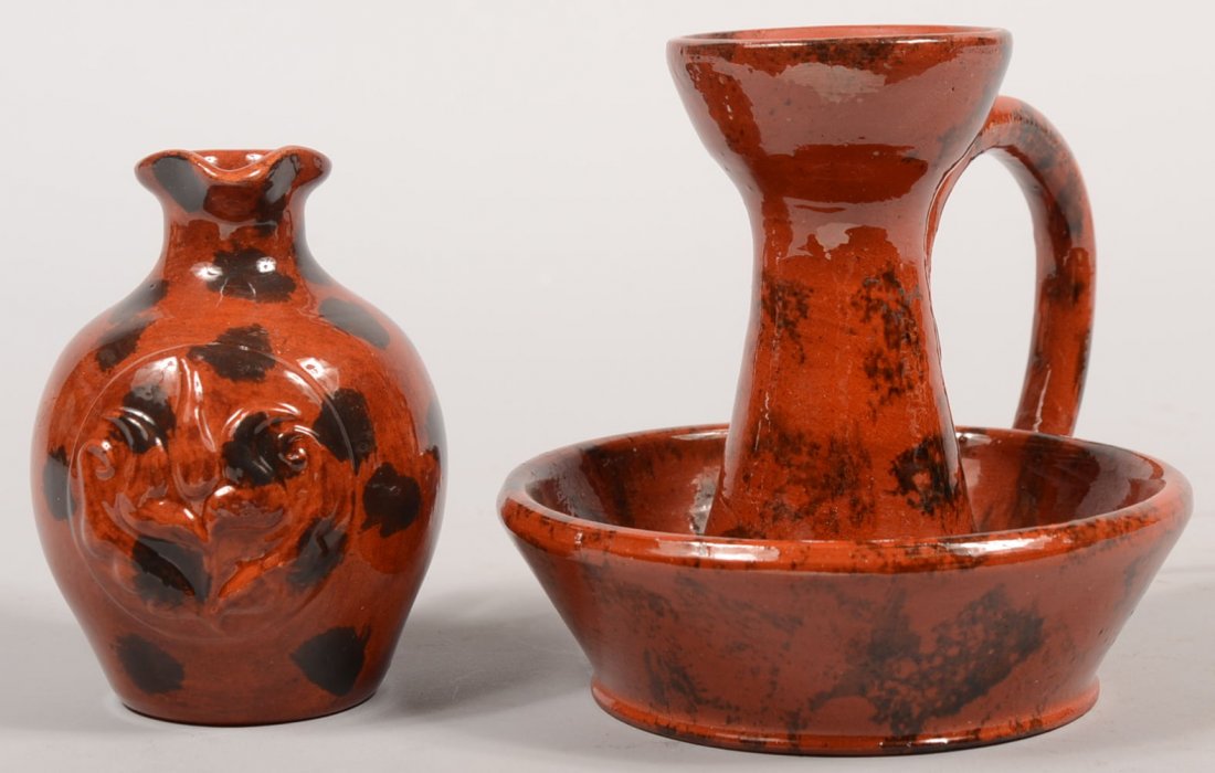 Two James Seagraves Spotted Redware Vessels. A vas: Two James Seagraves Spotted Redware Vessels. A vasi-form candle stick with saucer and applied loop handle decorated with manganese brush strokes and initialed only: "J S " on bottom. 5 1/8"h. X 5 1/4"