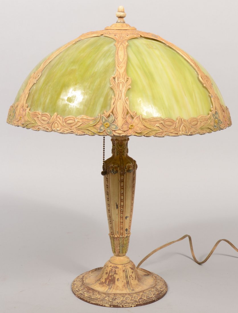Painted Cast Pot Metal Slag Glass Shade Table Lamp: Painted Cast Pot Metal Slag Glass Shade Table Lamp. Twin bulb electric lamp painted ivory with highlighted detail and a half spherical cast segmented shade with six green slag glass panels. 20 1/2"h. 