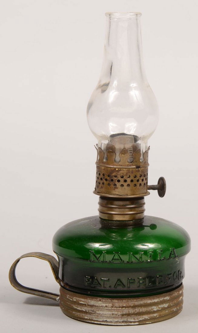 Green Glass Miniature Oil Lamp with Tin Finger Rin: Green Glass Miniature Oil Lamp with Tin Finger Ring. Embossed on glass: "Manila, Pat. Pend." secured into a threaded tin pan, painted gold, with a soldered tin finger ring. Font mounted with brass col