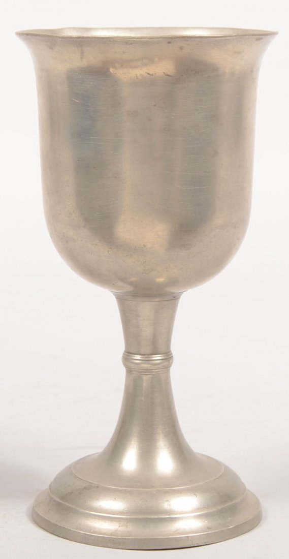 Large Pewter Chalice. Unmarked. Raised and molded : Large Pewter Chalice. Unmarked. Raised and molded base having a concave stem with wedding band mid knop supporting a tulip shaped cup with flared rim. 8 7/8"h. X 4 1/2"dia. Condition: Dent on mouth ri