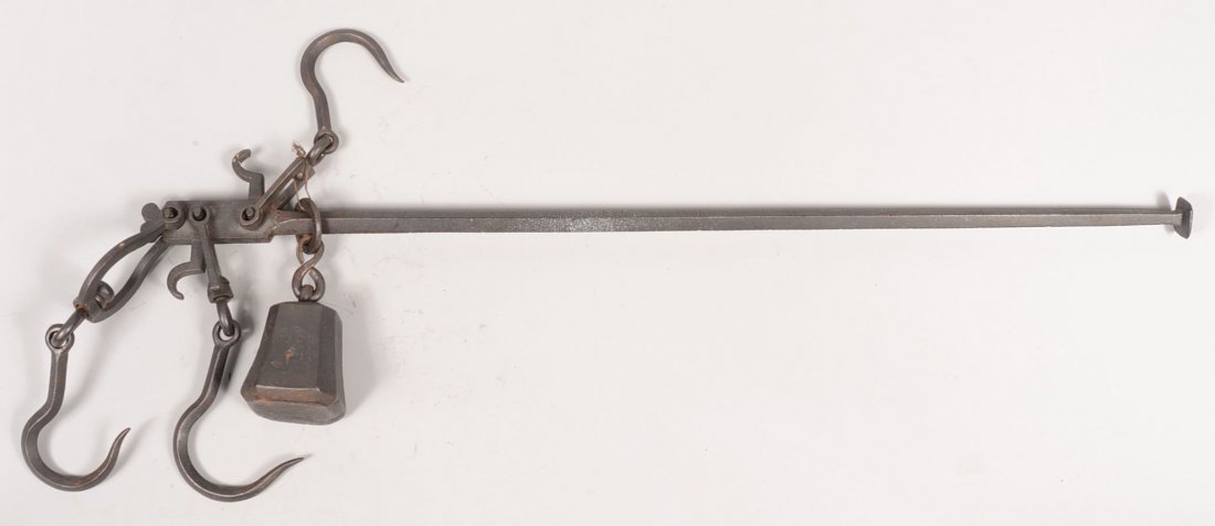 Wrought Iron Hanging Beam Scale with Counter Weigh: Wrought Iron Hanging Beam Scale with Counter Weight. Three sets of swivel hooks and a sliding octagonal counterweight marked: "1812, P." some decorative file work along with weight marks along balance