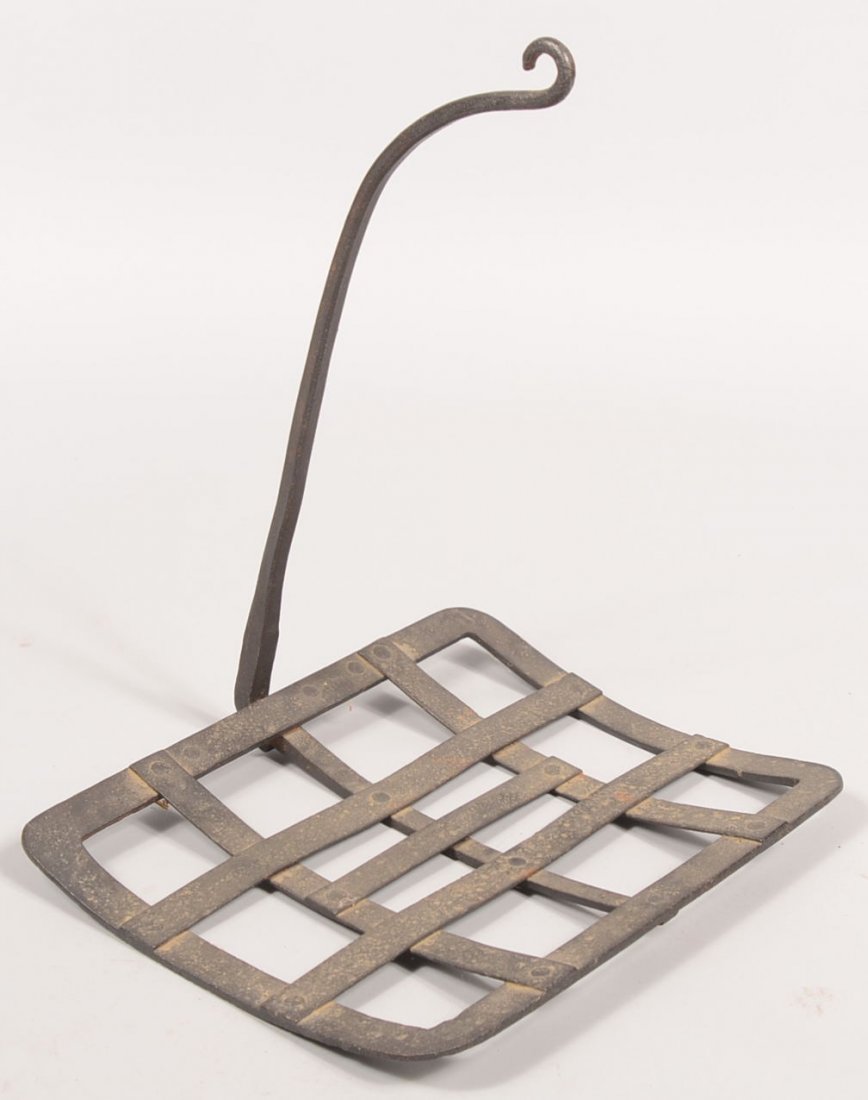 Wrought Iron Hanging Gridiron. Slightly curved and: Wrought Iron Hanging Gridiron. Slightly curved and flat strap iron basket supported by a square shank right angle and curved hanging arm. Nice early hearth primitive. Condition: Good, no damage.
