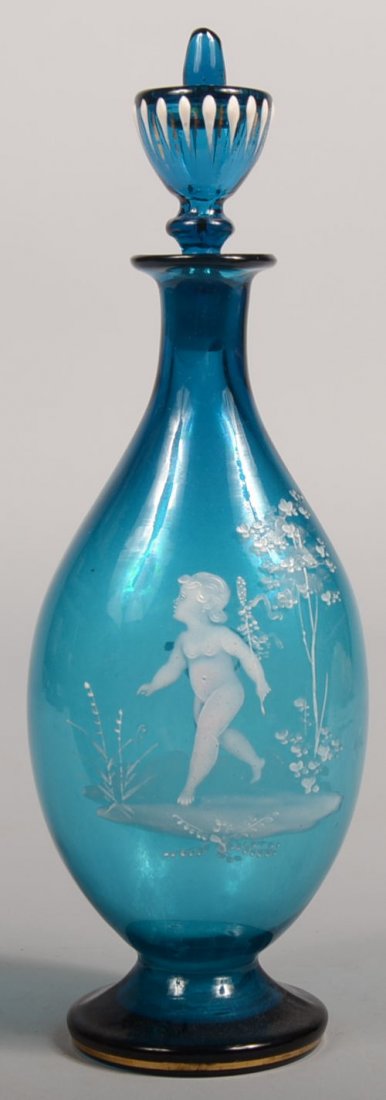 Mary Gregory White Painted Blue Decanter with Stop: Mary Gregory White Painted Blue Decanter with Stopper. Saffire blue blown glass bottle with a raised pad foot, ground pontil, tear drop body, flared mouth and paint decorated urn shaped stopper. Image