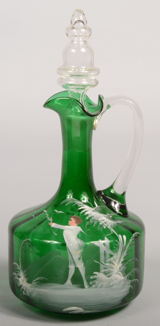 Mary Gregory White Painted Green Decanter. Emeral: Mary Gregory White Painted Green Decanter. Emerald green decanter with ground pontil, applied colorless loop handle and match ground stopper. Optically paneled body decorated with a young man in a fro