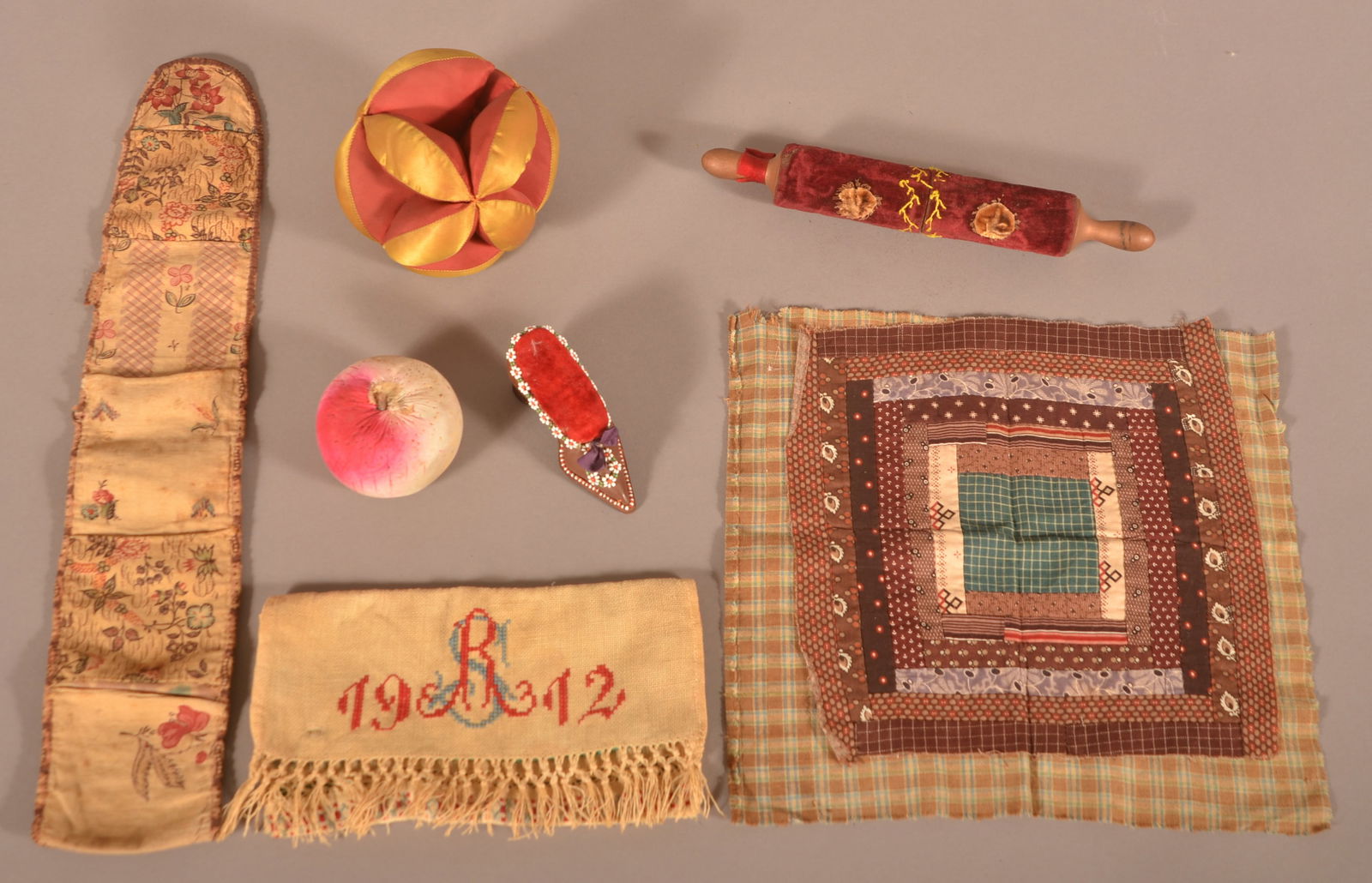 Lot of Antique Sewing-Related Items.: Lot of Antique Sewing-Related Items. Including a roll-up, 18"l., velour-covered rolling pin needle case (10-1/2"l.), patchwork piece and various pin cushions.