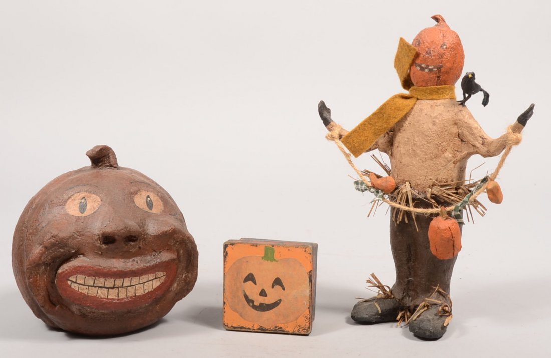 Two Craig Yenke Handmade Halloween Craft Decorative: Two Craig Yenke Handmade Halloween Craft Decoratives. A paper mache pumpkin with a grimacing human like face. Painted brown with details and marked on bottom. 6"h. Along with a pumpkin headed paper ma