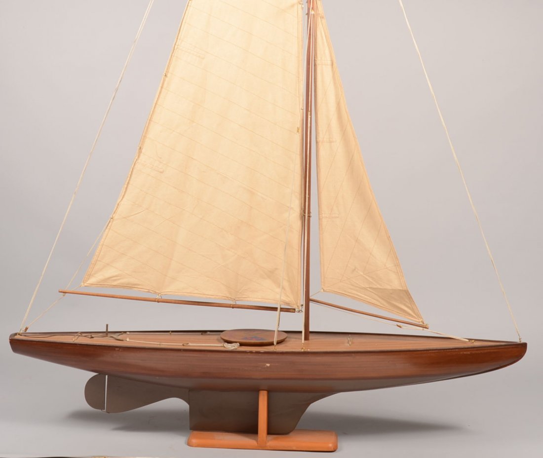 Hand Made Pond Sailing Boat. Hull boards laid up on: Hand Made Pond Sailing Boat. Hull boards laid up on wood rib frame, adjustable rudder, two piece mast with all rigging and cloth sails. Comes with a wood stand. Only markings are on deck hatch cover: