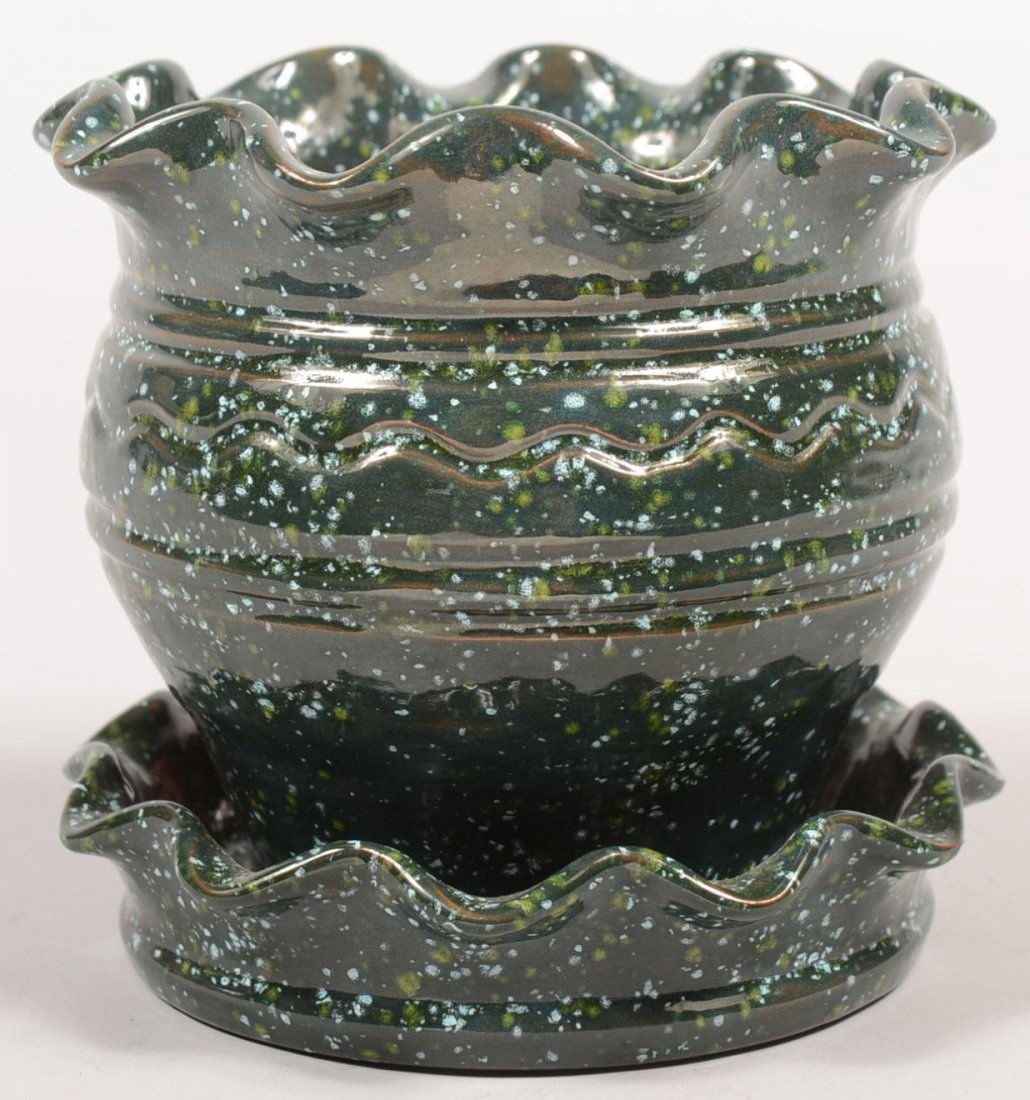 Breininger Pottery Fancy Green Glazed Flower Pot. R: Breininger Pottery Fancy Green Glazed Flower Pot. Redware vessel has rippled rim and ripple rim attached saucer, incised line decoration and covered with a dark green glaze with white and yellow spots