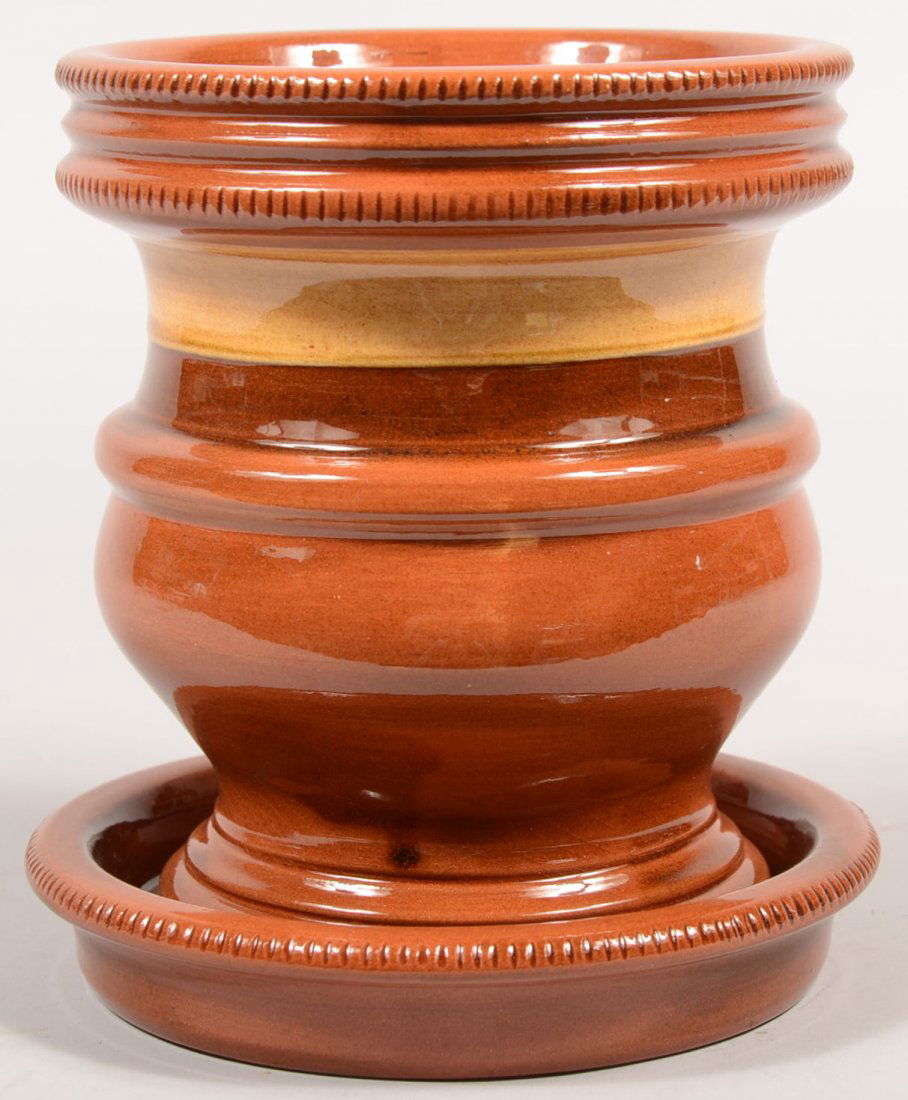 Breininger Redware Flower Pot with Tray. Molded bod: Breininger Redware Flower Pot with Tray. Molded body has ogee molded foot, triple beaded rim with coggle decoration and a slip band. Circular tray has coggle rim. Signed on bottoms: Breininger Pottery