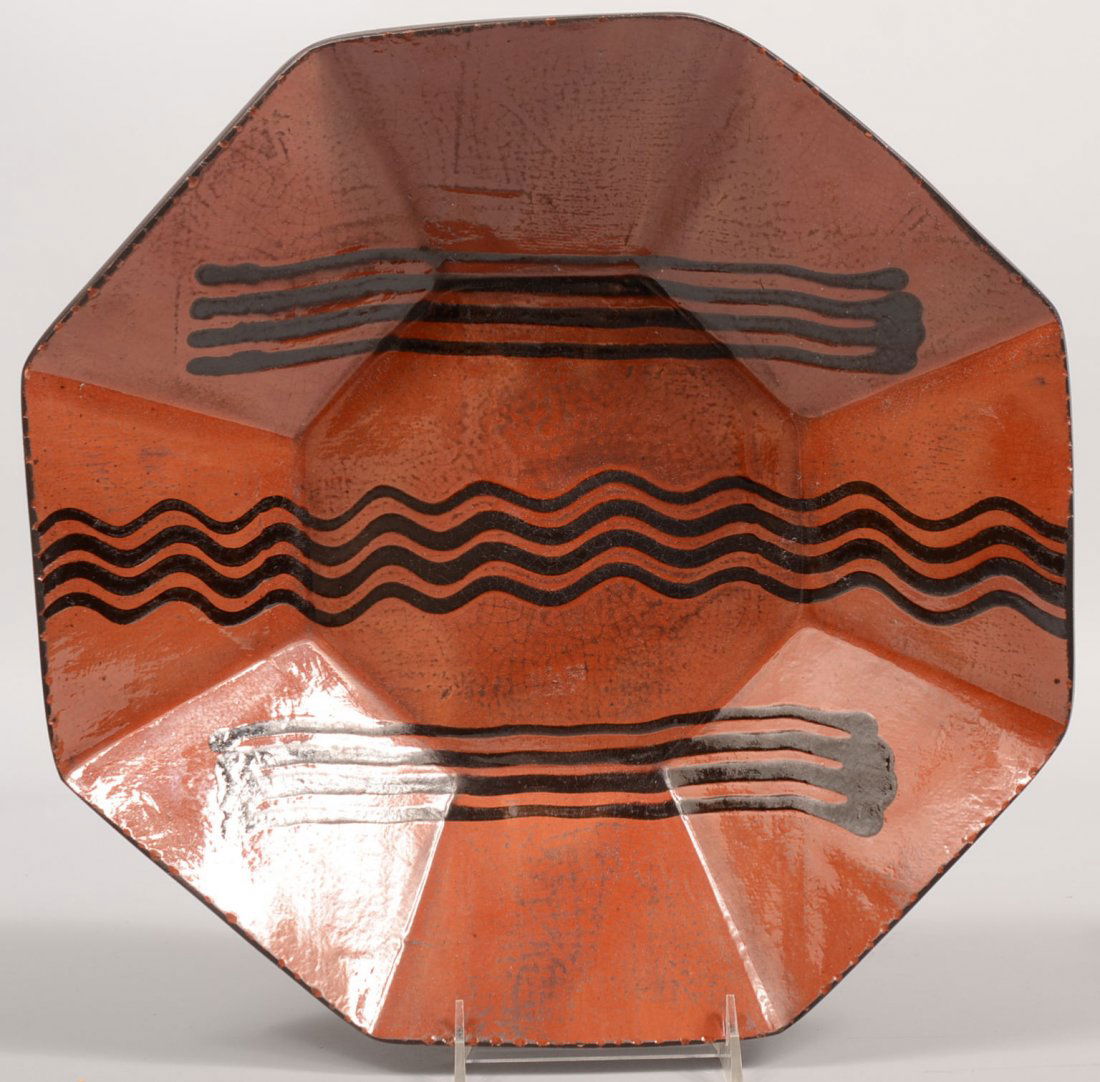 Large Octagonal Slab Side Redware Bowl. Interior ha: Large Octagonal Slab Side Redware Bowl. Interior has colorless glaze over three line designs, two sets of four straight flanking four serpentine line in black slip. Coggle rim. Exterior covered with b