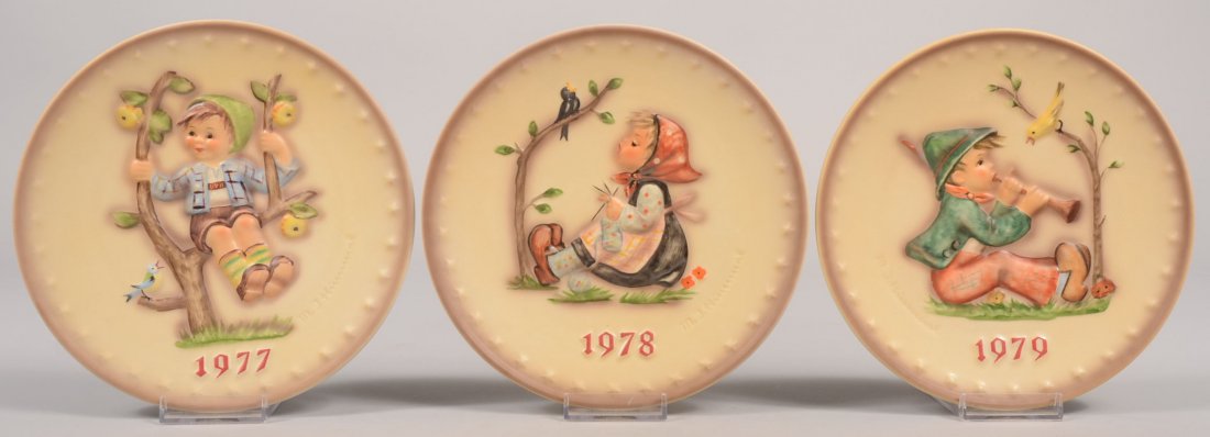 Three Hummel Annual Plates,1977, 1978, 1979. 1977: Three Hummel Annual Plates,1977, 1978, 1979. 1977 back marks include: Hum 270, Apple Tree Boy, TMK-5, 1972. 7 1/2"dia. 1978 back marks include: Hum 271, Happy Pastime, TMK-5, 1972. 1979 back marks inc