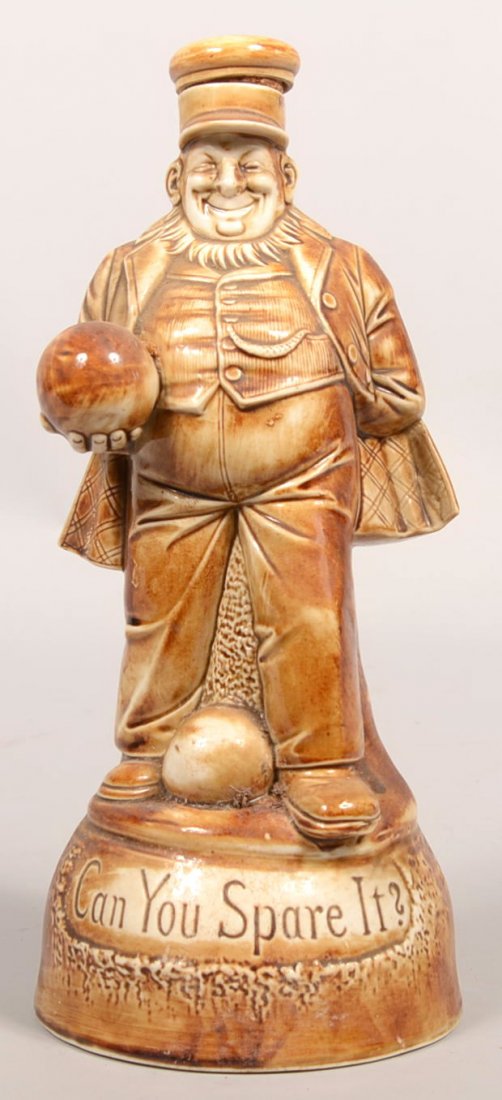 Porcelain Musical Whiskey Decanter of A Dutchman. : Porcelain Musical Whiskey Decanter of A Dutchman. Man has a bowling ball in hand and one between his legs. Cap crown holds cork. Circular base bears title: "Can You Spare It?" Set inside base cavity i