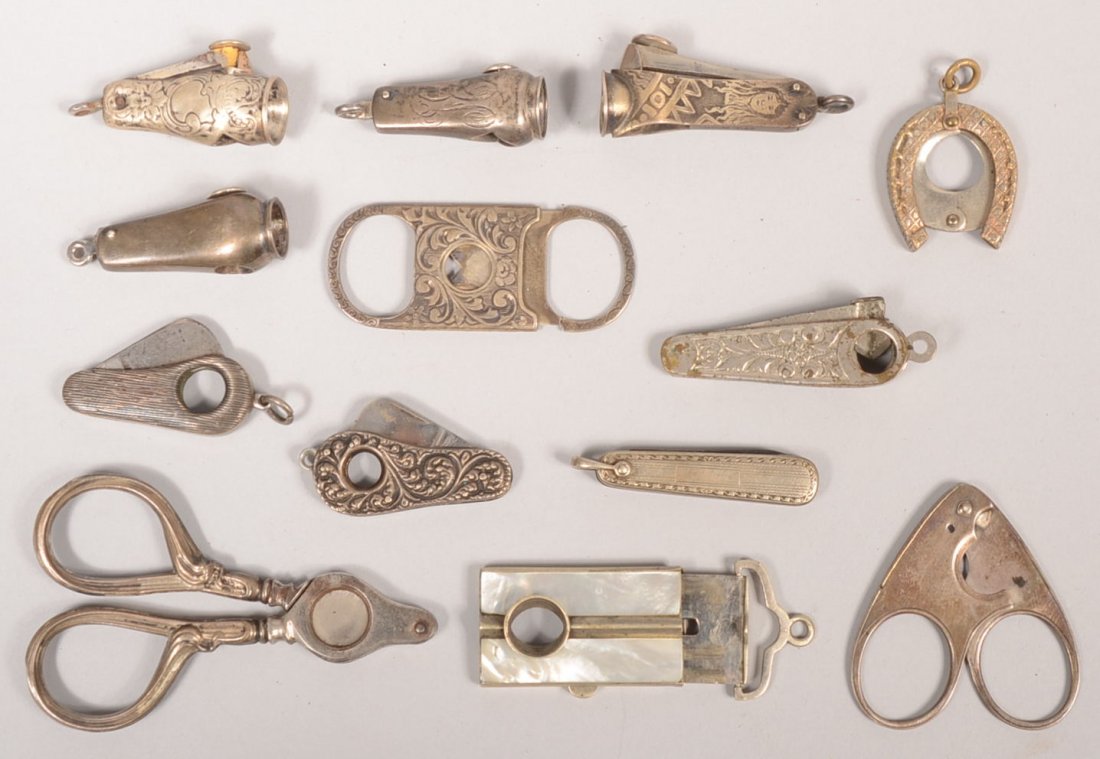 Thirteen Assorted Cigar Tip Cutters. Eight marked : Thirteen Assorted Cigar Tip Cutters. Eight marked Sterling. Five unmarked. Variety of designs, most watch chain fobs. 1 3/8"l. to 3"l.