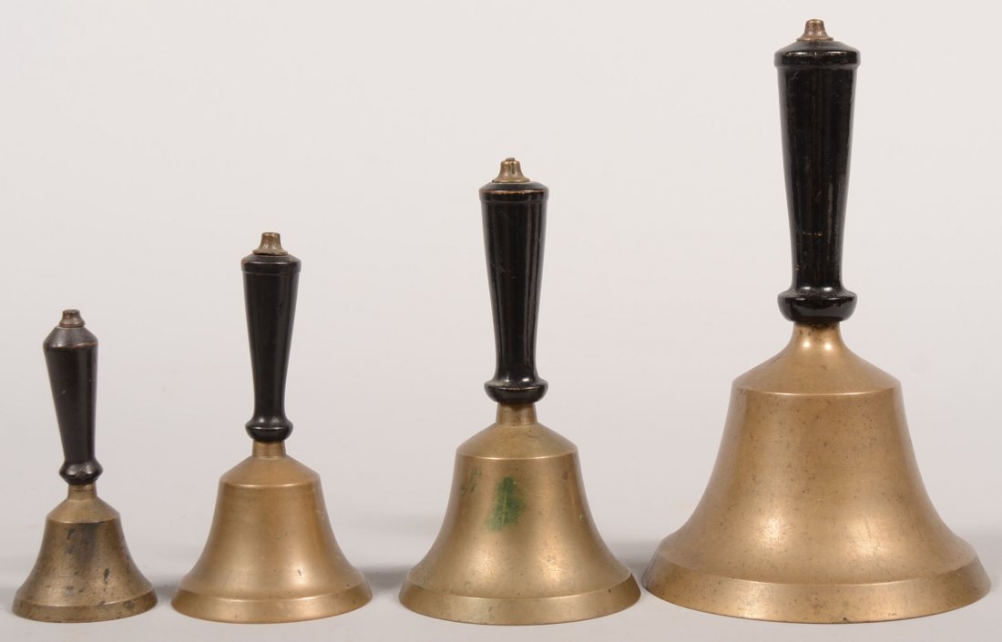Graduated Group of Brass Hand Bells. Four hand bel: Graduated Group of Brass Hand Bells. Four hand bells with similar shaped black wood handles and bell shape. All have cast iron clappers on heavy wire link. 9 3/8"h. X 5 7/8"dia., 7 1/2"h. X 4"dia., 6