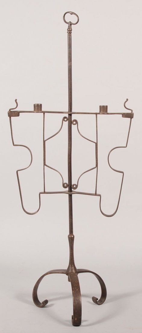 Wrought Iron Double Socket Candle Stand. Three cur: Wrought Iron Double Socket Candle Stand. Three curved legs support an iron standard with a key bow finial. Double spring supported superstructure has two candle sockets and to the outside ends two spr
