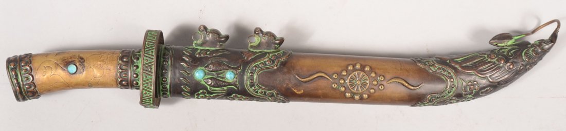 Large Asian Copper and Brass Sash Knife in Sheath.: Large Asian Copper and Brass Sash Knife in Sheath. Ornate decorative sheath has a lotus bud at tip, turquoise stones and animal head rings for hanging cord. Steel blade has a brass hilt with pressed d