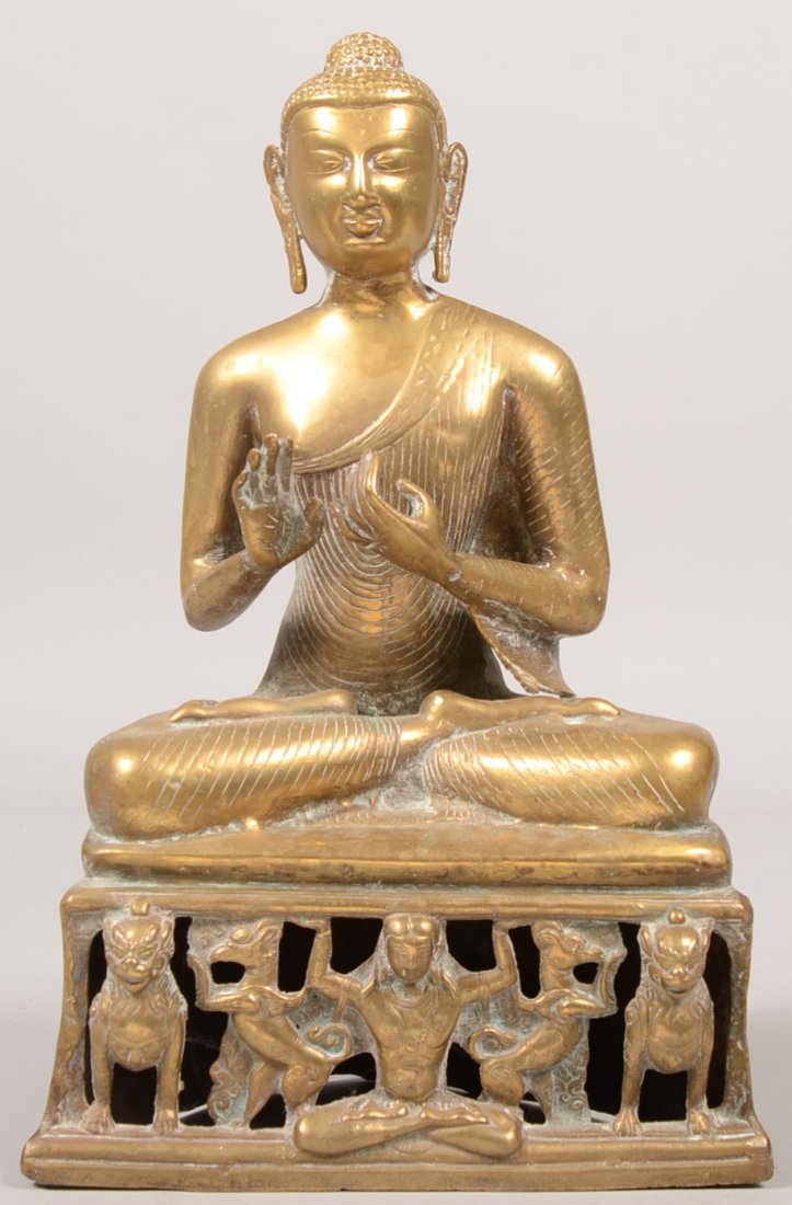 Cast Brass Buddha Seated Upon a Semi-Circular Base: Cast Brass Buddha Seated Upon a Semi-Circular Base. Front of base is pierced around small figures of dogs, birds and a man holding up the platform. Casting is hollow. Unmarked. 14 5/8"h.