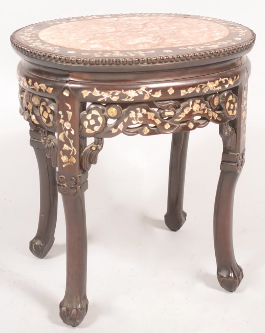 Carved and Mother of Pearl Inlaid Teak Stand. Squa: Carved and Mother of Pearl Inlaid Teak Stand. Square sectioned carved legs with claw and ball feet joined at the pierced and inlaid floral skirt under an oval top with MOP inlay, bead chain rim and br