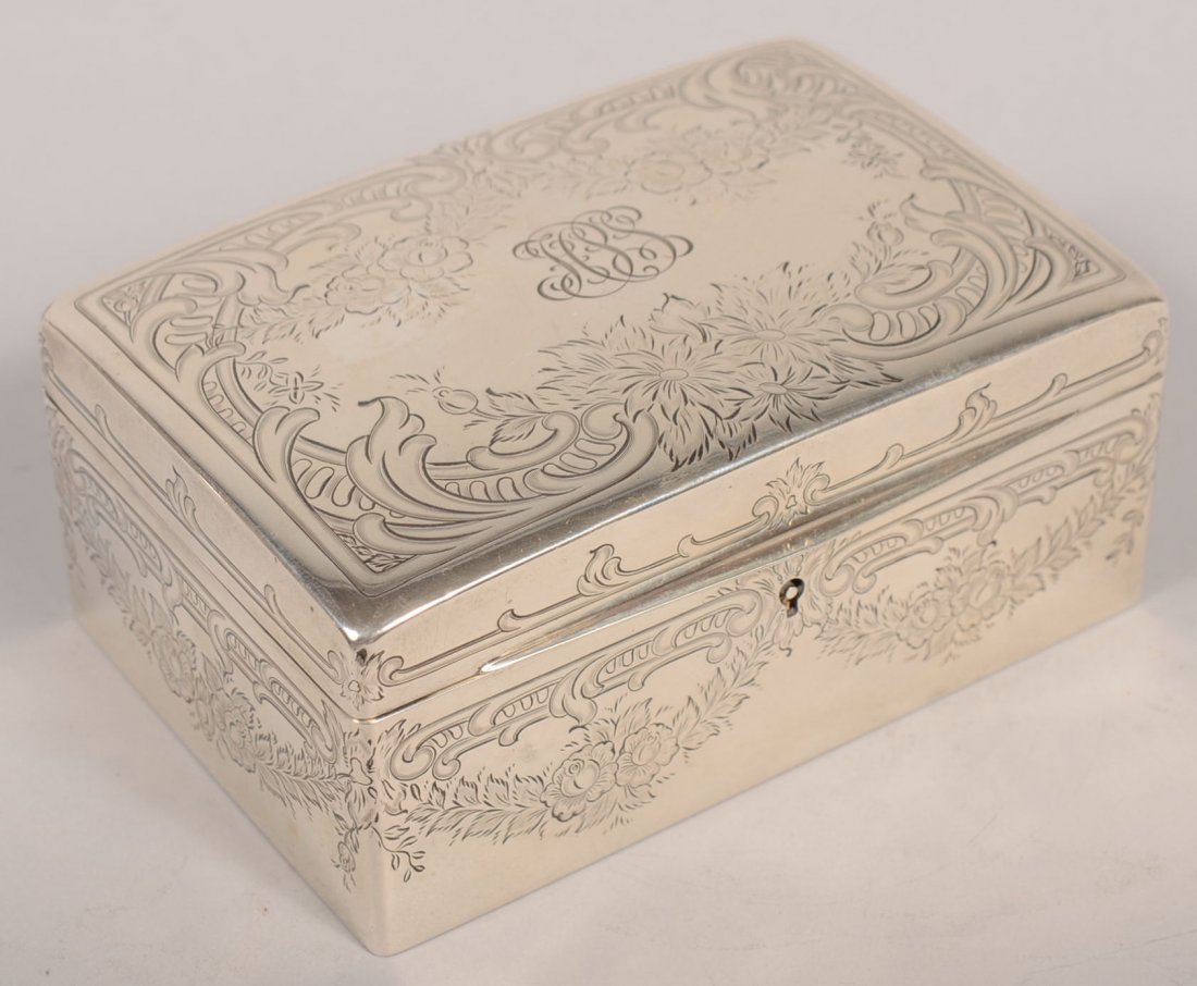 Sterling Jewelry Box. Marked with a reclining unic: Sterling Jewelry Box. Marked with a reclining unicorn on bottom, the surfaced of this box is engraved with floral groups and wreathes with stylized scrolling. Hinged lid has a lift bill and a lock. In
