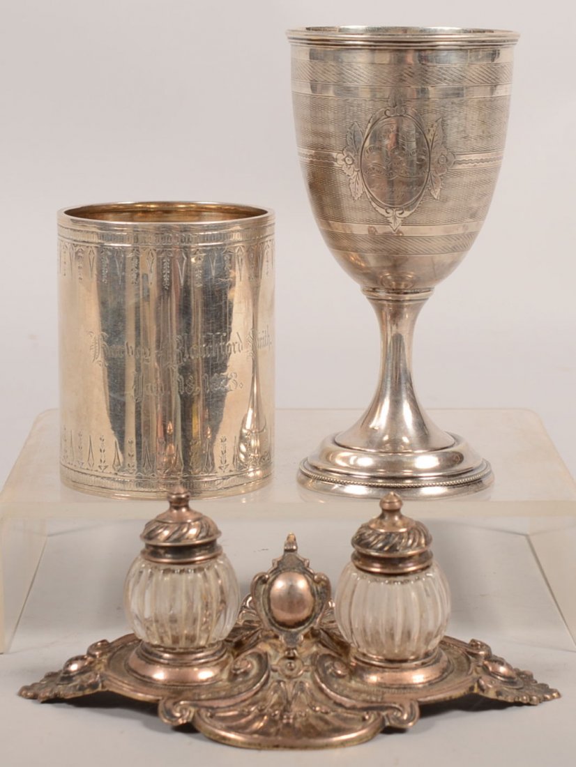 Three Pieces of Silver. A Sterling mug marked: "Ha: Three Pieces of Silver. A Sterling mug marked: "Harley Blatchford Smith, Jan. 18, 1873" on face with applied handle, 3 5/8"h. X 2 7/8"dia., 7.4 ozt.; a coin silver shaker caddy with two glass shakers 