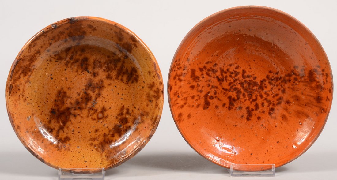 Two Manganese Spattered Redware Dishes. A redware: Two Manganese Spattered Redware Dishes. A redware dish having yellow slip glazing with manganese spatter, 1 5/8"h. X 7"dia. Along with a clear glazed redware dish with a band of manganese spatter, 1 1