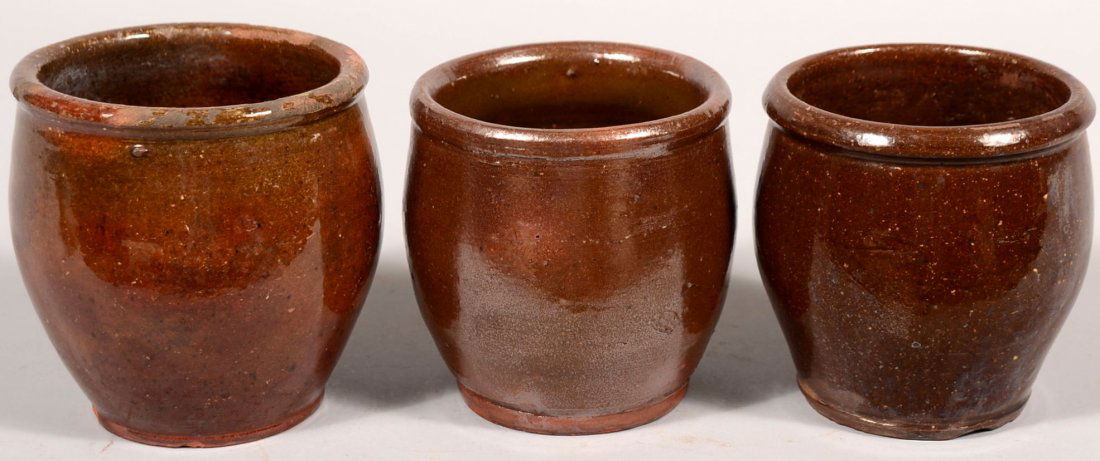 Three Smaller Redware Open Crocks. Ovoid shape wit: Three Smaller Redware Open Crocks. Ovoid shape with rim bead and glazed inside and out. 4 3/4"h. and two: 4 1/2"h.