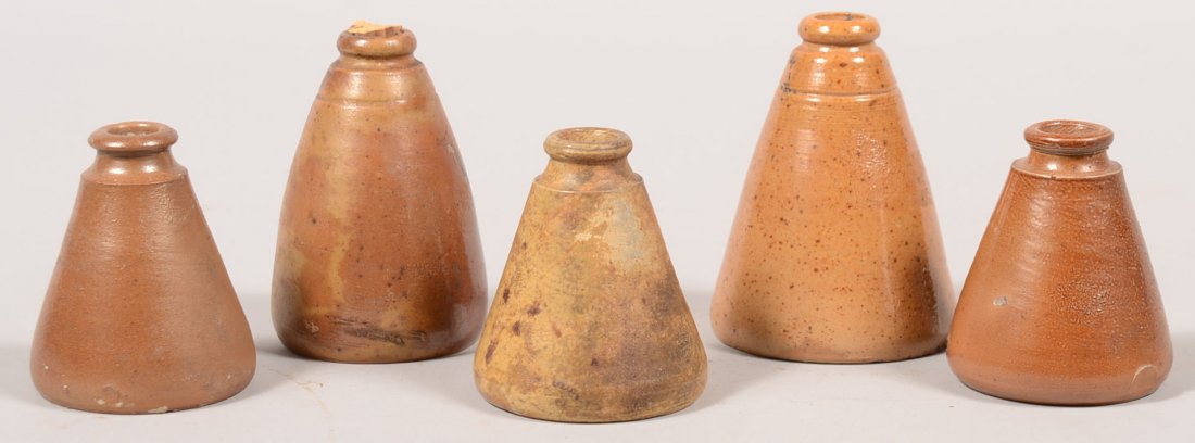 Five Conical Stoneware Ink Bottles. All salt glaze: Five Conical Stoneware Ink Bottles. All salt glazed and in colors from gray to brown. 3 1/2"; 3 1/4"; 3"; 3"; 2 3/4" heights.