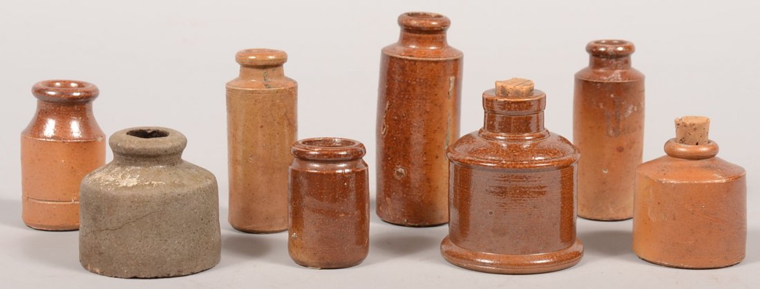 Eight Cylindrical Stoneware Ink Bottles. A variety: Eight Cylindrical Stoneware Ink Bottles. A variety of sizes in this instant collection. Tall and slender with a brown glaze: 4", 3 1/4", 2 5/8", 2 1/8" and short and wide, one in gray: 3", 2 1/4", 2"h